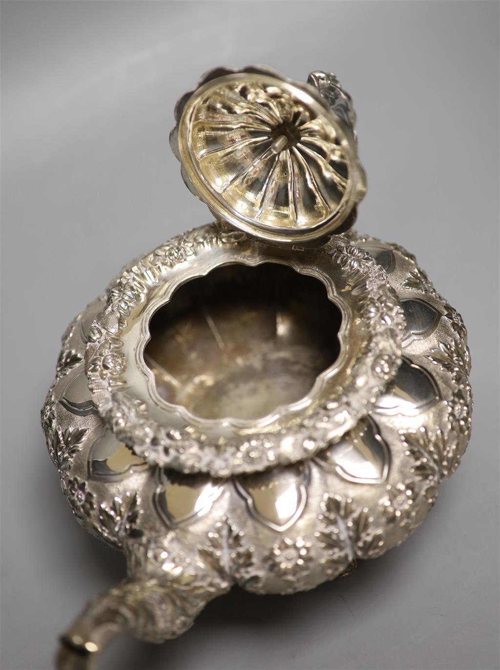 A George IV silver squat melon shaped teapot, embossed with flowers, The Barnards, London, 1829, gross 28oz.